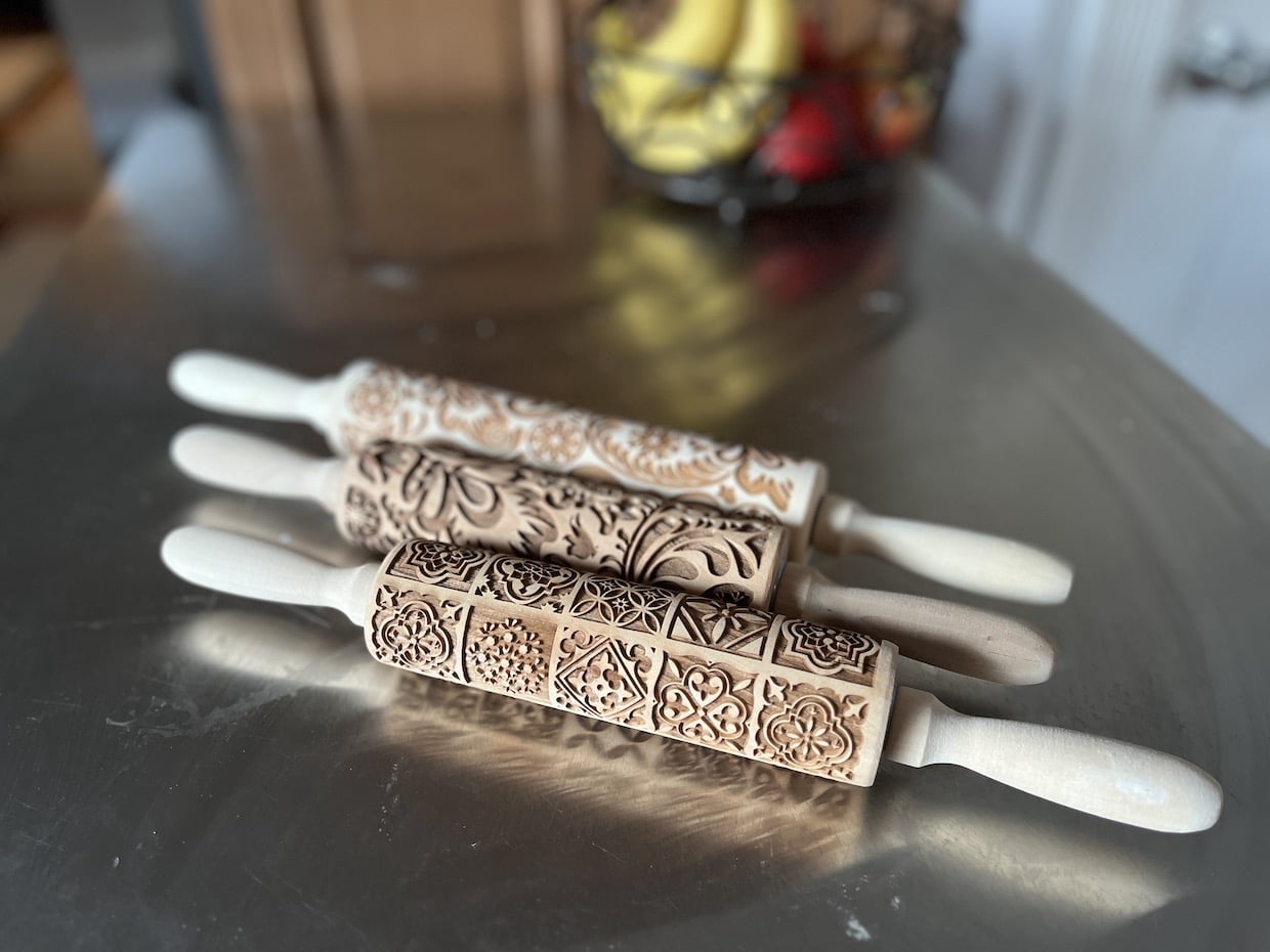 three embossed rolling pins with different designs